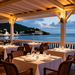 Caribbean Holidays, October Saint Barth, Elegant outdoor restaurant in Gustavia, Saint Barth&eacute;lemy, with tables set for dinner, harbour views and warm evening light