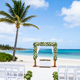 Caribbean Holidays, October Weddings, Elegant beach wedding ceremony with white chairs, simple flowers and palm trees on Tortola, British Virgin Islands