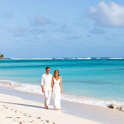 Caribbean Holidays, October Weddings, Newly married couple walking barefoot along a quiet Saint Barth&eacute;lemy beach after their October wedding, with calm turquoise water