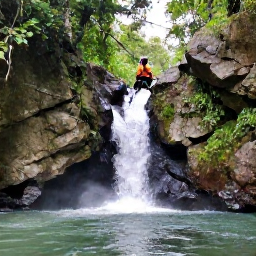 Caribbean Holidays, Puerto Rico Adventures, Visitors canyoning through a rocky Puerto Rican river with waterfalls and tropical forest