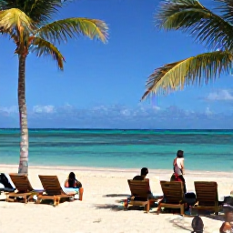 Caribbean Holidays, Puerto Rico Business Class, Palm-fringed Puerto Rican beach with clear turquoise water, sun loungers and visitors enjoying a warm July afternoon