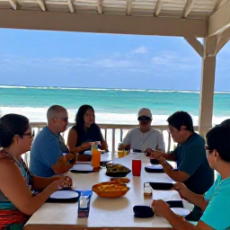 Caribbean Holidays, Puerto Rico Cooking, Visitors enjoying a Puerto Rican cooking class and shared meal on a shaded terrace overlooking the Caribbean coast