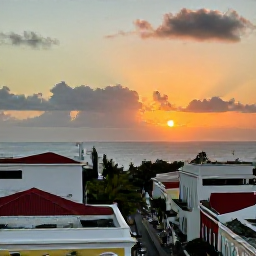 Caribbean Holidays, Puerto Rico June, Sunset over San Juan with palm-lined streets, historic rooftops and the Caribbean Sea in the background