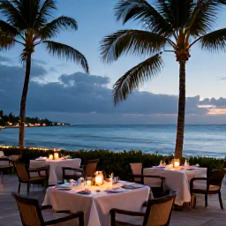 Caribbean Holidays, Puerto Rico Luxury, Romantic beachfront restaurant in Puerto Rico at dusk, with elegant tables, candles, palm trees and a calm sea