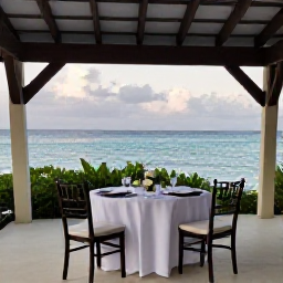 Caribbean Holidays, Quiet Caribbean Weddings, A small Caribbean wedding reception at a shaded terrace overlooking the sea, with a beautifully laid table for two and soft evening light