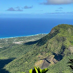 Caribbean Holidays, Rainforest Hikes, A panoramic Caribbean rainforest viewpoint overlooking lush green mountains, a winding coastline and brilliant blue sea under a clear sky