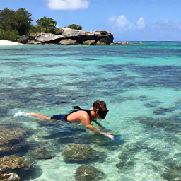 Caribbean Holidays, Saint Barthelemy Nature, Snorkeller exploring clear shallow water beside a Saint Barthelemy beach, with colourful fish, coral and rocky coastline visible