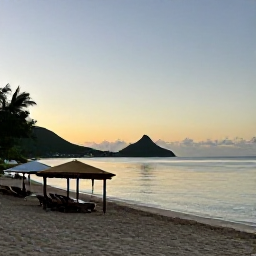 Caribbean Holidays, Saint Kitts Beaches, Frigate Bay beach at sunset with calm water, beach bars, loungers and distant green hills