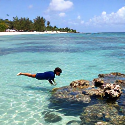 Caribbean Holidays, Saint Kitts Beaches, Snorkeller exploring clear shallow water near Saint Kitts, with colourful fish, coral and a sandy beach in the background