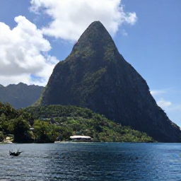 Caribbean Holidays, Saint Lucia August, Dramatic Pitons rising above green rainforest and calm blue water in Saint Lucia