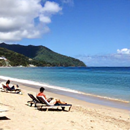 Caribbean Holidays, Saint Lucia Beaches, Travellers relaxing on Reduit Beach in Saint Lucia, with loungers, clear blue sea and the green hills of the island in the distance