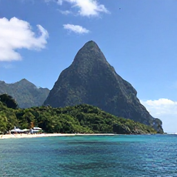 Caribbean Holidays, Saint Lucia September, The Pitons rising above the calm Caribbean Sea beside a lush Saint Lucia coastline