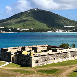 Caribbean Holidays, Saint Martin Culture, Historic Fort Louis overlooking Marigot Bay, with green hills, blue water and visitors exploring the ruins