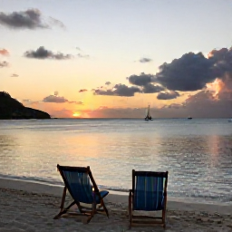 Caribbean Holidays, Saint Martin Wellness, Sunset over a quiet Saint Martin beach with two deckchairs, calm sea, warm evening light and distant sailboats