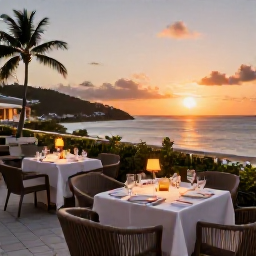 Caribbean Holidays, Saint Vincent Business Class, Elegant Caribbean resort terrace overlooking the sea at sunset, with a relaxed festive dining setting