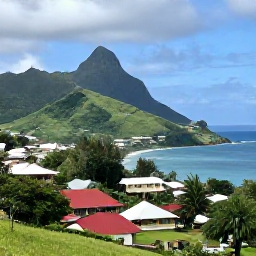 Caribbean Holidays, Saint Vincent Culture, Scenic village and coastal landscape on Saint Vincent with green hills, traditional homes and Caribbean sea