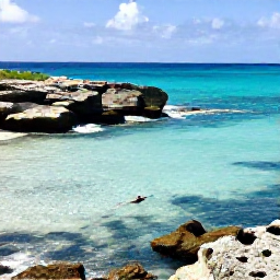 Caribbean Holidays, September Adventures, A sunny Cura&ccedil;ao coastline in September with turquoise water, rugged rocks and a small snorkeller near shore