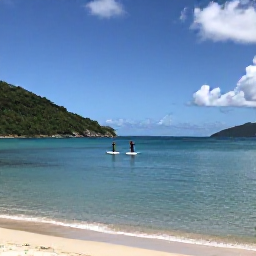 Caribbean Holidays, September Adventures, Stand-up paddleboarders gliding across calm Caribbean water near a sandy beach in the United States Virgin Islands
