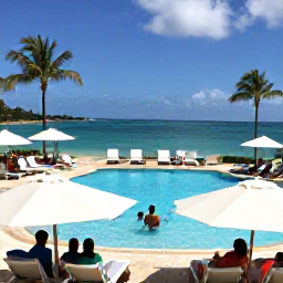 Caribbean Holidays, September All Inclusive, Guests relaxing beside a Caribbean resort pool in the United States Virgin Islands, palm trees, sun loungers and ocean views in September