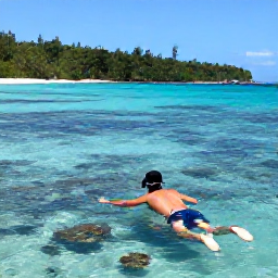 Caribbean Holidays, September Getaway, Snorkeller exploring a clear Caribbean bay near St John, United States Virgin Islands, with colourful fish, coral and a forested shoreline
