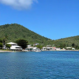 Caribbean Holidays, September Holidays, Relaxed Caribbean coastline on Saint Vincent in September with a small fishing village, green hills and calm blue water