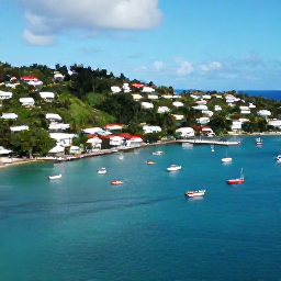 Caribbean Holidays, September Instagram Spots, Aerial-style view of Bequia harbour with colourful boats, hillside homes and sparkling Caribbean water under a bright September sky