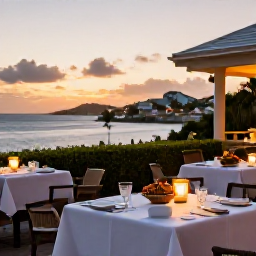Caribbean Holidays, September Luxury Holidays, Elegant Caribbean restaurant terrace at sunset in St Thomas, fresh seafood dinner, soft lighting and harbour views