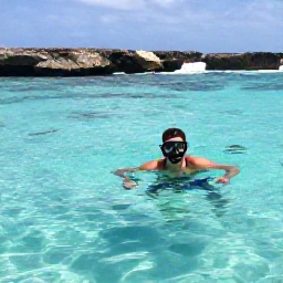 Caribbean Holidays, September Solo Holidays, A solo traveller snorkelling in clear Caribbean water near Aruba, with colourful fish and rocky coastline