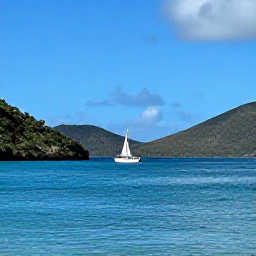 Caribbean Holidays, September Tours, A bright September morning in the British Virgin Islands, with a sailing boat passing between green hills and calm turquoise bays