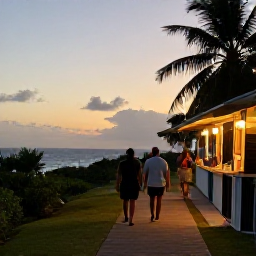 Caribbean Holidays, September Walking, A relaxed Caribbean evening in Tobago with walkers dining outdoors near the sea after a day on the trails
