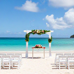 Caribbean Holidays, September Weddings, Antigua beach wedding ceremony with white chairs, tropical flowers and turquoise water under a bright sky