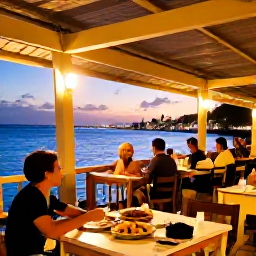 Caribbean Holidays, Solo Holidays Cura&ccedil;ao, A relaxed evening scene at a Cura&ccedil;ao waterfront restaurant, with warm lights, local food and a solo diner enjoying the Caribbean atmosphere