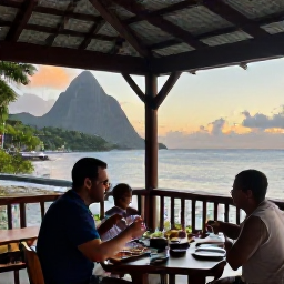 Caribbean Holidays, Solo Holidays, Friendly solo diner enjoying Creole food at a relaxed open-air restaurant overlooking the Saint Lucia coastline at sunset