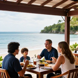 Caribbean Holidays, Trinidad Family Holidays, Parents and children sharing a relaxed dinner at an open-air Caribbean restaurant beside the sea in Tobago