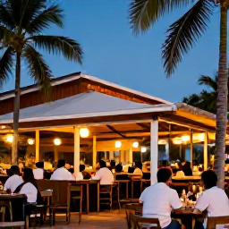 Caribbean Holidays, Trinidad June Breaks, Relaxed Port of Spain evening with warmly lit restaurants, palm trees and people enjoying Caribbean nightlife