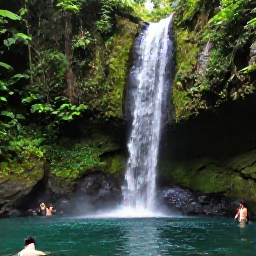 Caribbean Holidays, Trinidad Nature Holidays, A clear forest waterfall in Trinidad, surrounded by tropical plants, mossy rocks and visitors cooling off in the pool