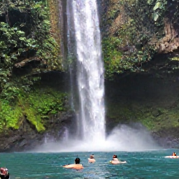 Caribbean Holidays, Trinidad October Adventures, A clear tropical waterfall surrounded by rainforest in Trinidad, with visitors swimming in the pool beneath it