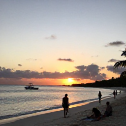 Caribbean Holidays, Turks Caicos April, A relaxed sunset scene on Grace Bay in Turks and Caicos, with a small boat offshore, warm evening light and holidaymakers walking along the beach