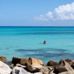 Caribbean Holidays, Turks Caicos August, Calm clear Caribbean sea with snorkellers viewing colourful fish and coral near Providenciales, Turks and Caicos, in August