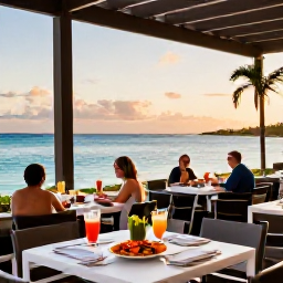 Caribbean Holidays, Turks Caicos Business Class, A stylish beachfront restaurant in Turks and Caicos at sunset, with fresh seafood, tropical drinks and diners overlooking the sea