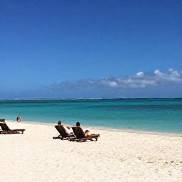 Caribbean Holidays, Turks Caicos Business Class, Grace Bay Beach in April with soft white sand, clear turquoise water, sun loungers and a few relaxed visitors