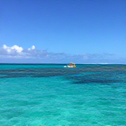Caribbean Holidays, Turks Caicos May, A small boat travelling across turquoise Caribbean water near the coral reefs of Providenciales, Turks and Caicos, under a clear blue sky