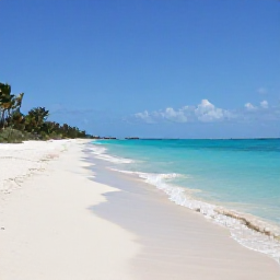 Caribbean Holidays, Turks Caicos May, A wide view of Grace Bay Beach in the Turks and Caicos Islands on a bright May morning, with clear turquoise water, soft white sand and a few palm trees