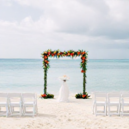 Caribbean Holidays, Turks Caicos Weddings, Elegant small beach wedding ceremony in Turks and Caicos with white chairs, tropical flowers and calm turquoise water