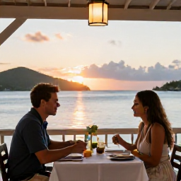 Caribbean Holidays, US Virgin Islands Couples, Couple dining at an open air waterfront restaurant in the United States Virgin Islands at sunset