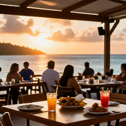 Caribbean Holidays, US Virgin Islands June, Outdoor Caribbean restaurant in the United States Virgin Islands at sunset, with local food, tropical drinks and diners beside the sea