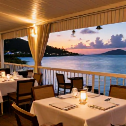 Caribbean Holidays, USVI Business Class, A relaxed evening waterfront restaurant in the US Virgin Islands, with fresh seafood, warm lights and a colourful Caribbean sunset