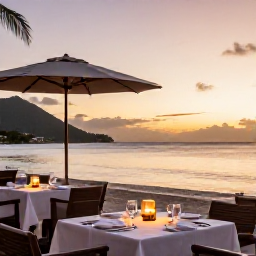 Caribbean Holidays, USVI Business Class, Elegant Caribbean beachfront restaurant at sunset in the US Virgin Islands, outdoor tables, gentle sea and warm evening light
