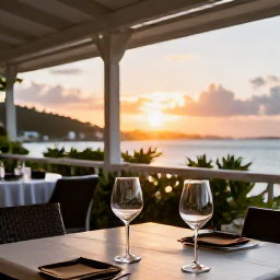 Caribbean Holidays, USVI Wine Tasting, Elegant outdoor restaurant terrace in St Thomas with wine glasses, Caribbean sunset and views over the harbour